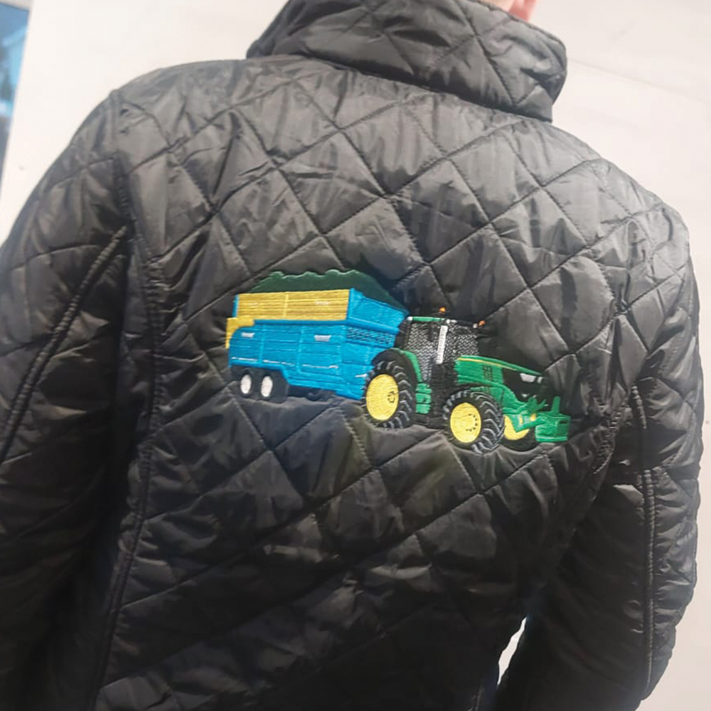 Tractor with grain trailer embroidery stitched on quilted puffer jacket